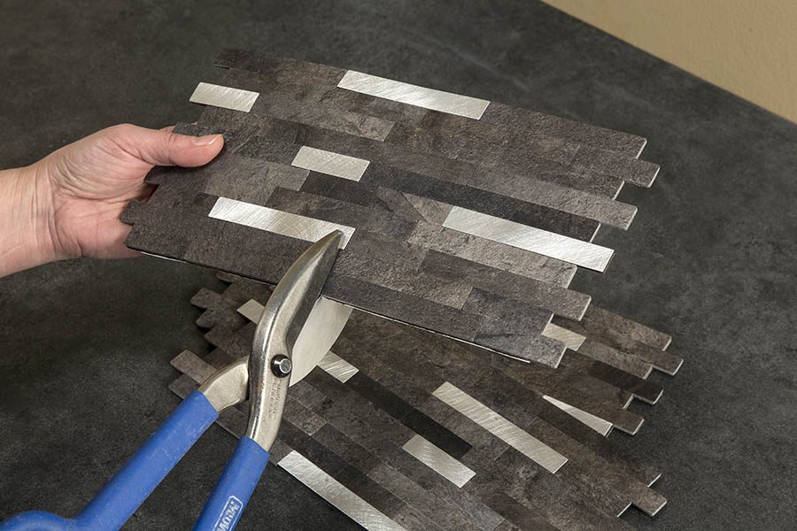 Cut the tile using tin snips or other cutting tools